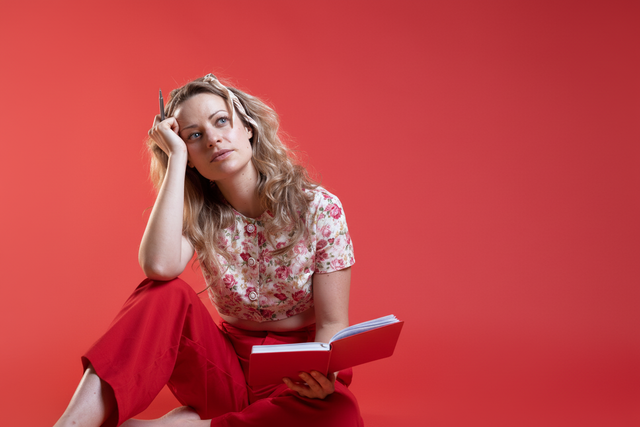 Woman with red background, pants and book